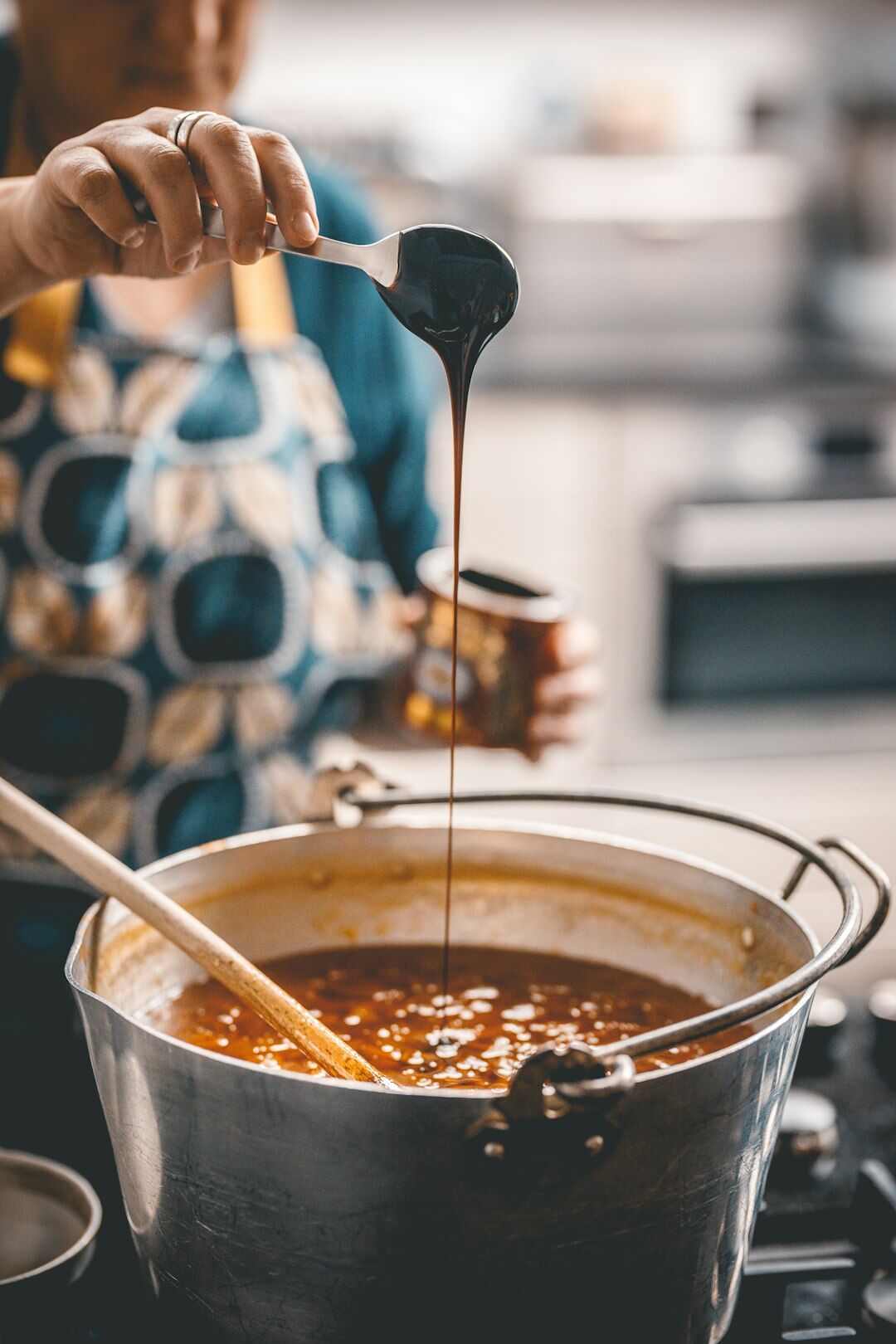 woman stirring fruit jam pot